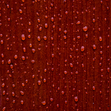 abstract raindrops pattern on red wooden boardの写真素材