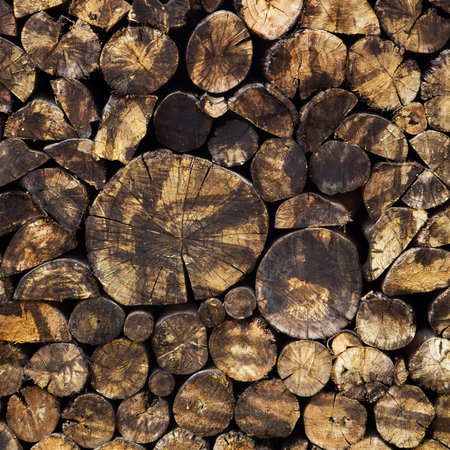 Dry chopped firewood logs stacked up on top of each other in a pile