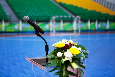 Close up of microphone on the podium with a bouquet of flowers in the indoor arena is fantastic.の写真素材