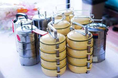 tiffin carrier, Still life with colorful retro food carrier on wood table backgroundの写真素材