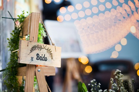 word ' bride' on wood hanging and bokeh light in partyの写真素材