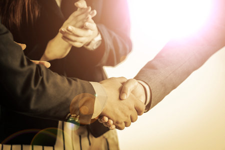 Group of business people meeting shaking hands together, business outdoor meeting concept.