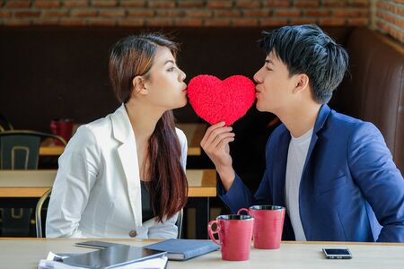 Man and woman holding red heart - Love conceptの写真素材