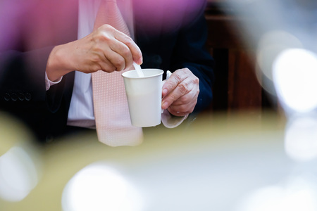 Guy with hot coffee in a glass paper of white paperの写真素材
