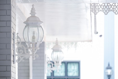 Old iron street lantern on a wallの写真素材