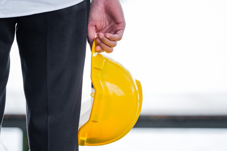 Man holding yellow helmet close up
