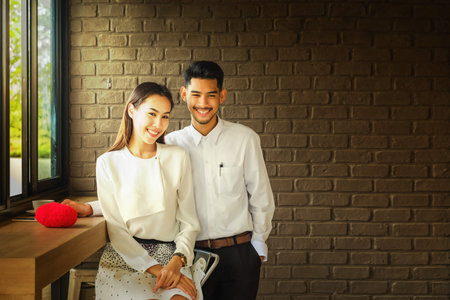 Asian Lover man and woman enjoy with a cup of coffee in coffee shop.の写真素材