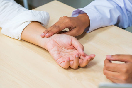 Medical examination. The doctor examines the patient's heart rate by holding his wrist.