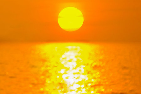 Big sun setting in the sea nature composition and blurry focus