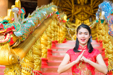 Portrait chinese woman red dress traditional cheongsam in chinese temple.の写真素材
