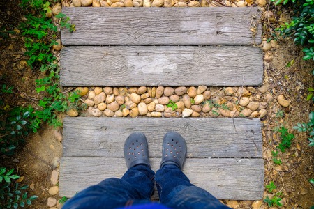 Selfie Foots standing on a wooden floor, garden walkwayの写真素材