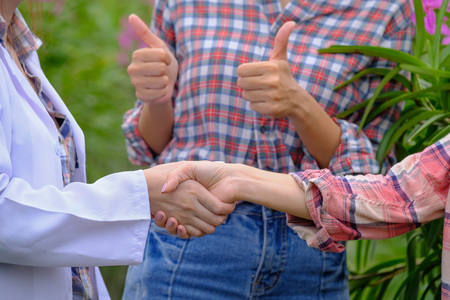 Handshaking of researchers and orchid garden ownersの写真素材