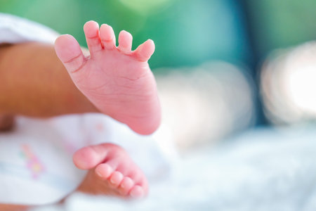 Newborn baby on a white blanket    tiny baby feet closeup