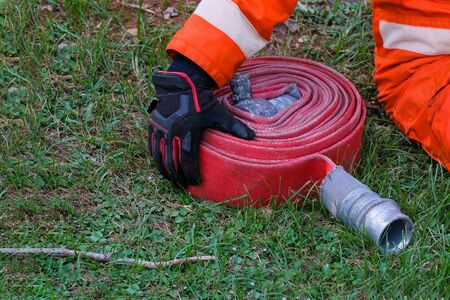 Firefighters and Fire hose coil  fire and rescue training school regularly to get ready - help, fire protection conceptの写真素材
