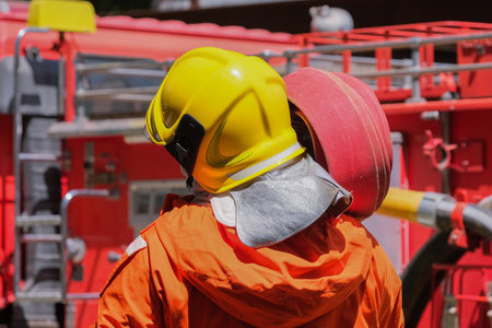 Firefighters training, Team practice to fighting with fire in emergency situation. A fireman carry a...
