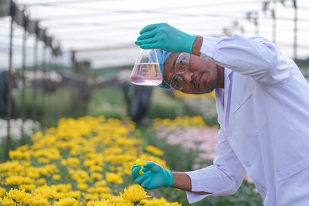 A male scientist in a protective suit is analyzing gladiolus and nature in the summer.