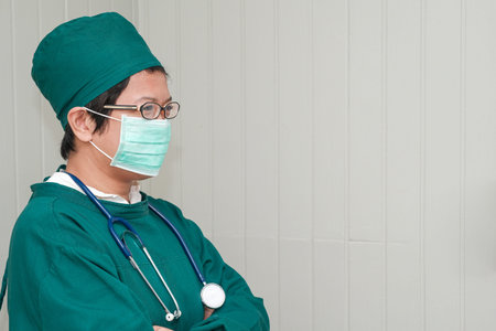 Woman surgeon in green scrubs and copy spaceの写真素材