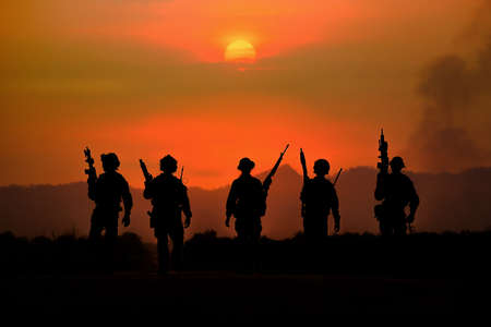 The silhouette of a military soldier with the sun as a Marine Corps for military operationsの写真素材
