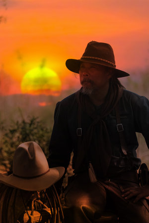 The silhouette of the cowboy and the setting sunset