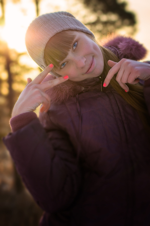 The beautiful, young girl, with bright nails, playfully gesticulates.の写真素材
