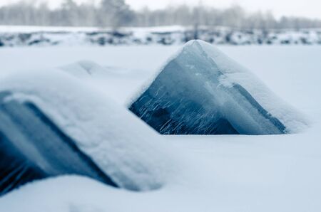 Ice pyramids sticking out of snow.の写真素材