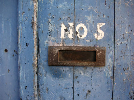 Old blue door with NO 5 written on itの写真素材
