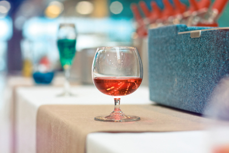 Glass of red wine. Festive cocktail in a cafe restaurant. Background with bokeh for designの写真素材