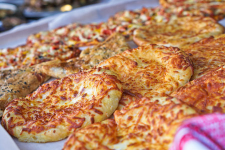 Ready pizza with meat and sausage background with vegetables. Summer holidays and food in nature....