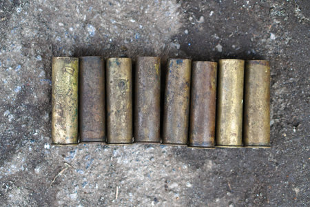 Sleeve from the gun on the background of a concrete structure. Military and hunting subjects for...
