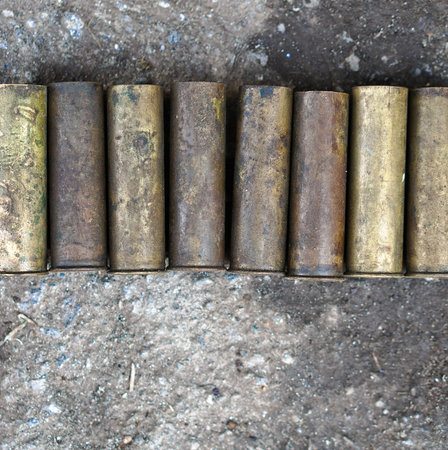 Sleeve from the gun on the background of a concrete structure. Military and hunting subjects for...