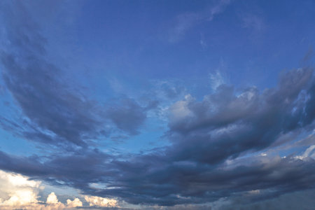 Beautiful white and gray clouds against the blue sky. Summer and autumn day with a view from the...