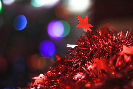 Beautiful Christmas red star on a background of bokeh garlands. Christmas theme designの写真素材