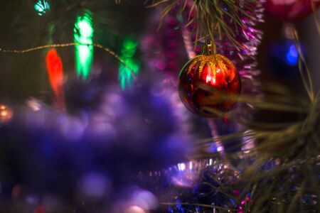 Christmas tree decorated with toys and a garland. New year background for your design. Seasonal holidays in winterの写真素材