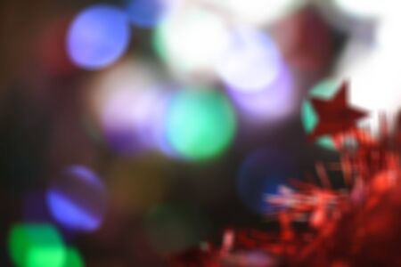 Beautiful Christmas red star on a background of bokeh garlands. Christmas theme designの写真素材
