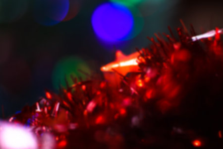 Beautiful Christmas red star on a background of bokeh garlands. Christmas theme design