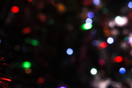 Beautiful Christmas background with garlands and bokeh. New year  multi-colored picture. Abstract...