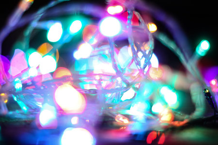 Beautiful Christmas background with garlands and bokeh. New year  multi-colored picture. Abstract...