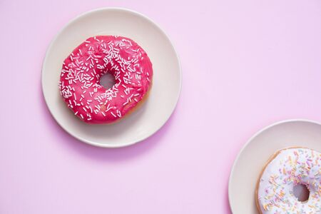 Beautiful juicy donut with a sweet cream.
Cupcake on a pink background for kitchen design.の写真素材