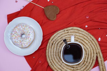 Beautiful juicy donuts with coffee in plates on a decorative tray. February valentine's day greeting card. background for kitchen designの写真素材
