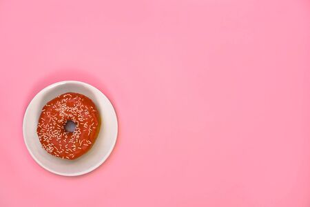 Beautiful juicy donut with a sweet cream.
Cupcake on a pink background for kitchen design.の写真素材