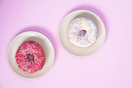Beautiful juicy donut with a sweet cream.
Cupcake on a pink background for kitchen design.の写真素材