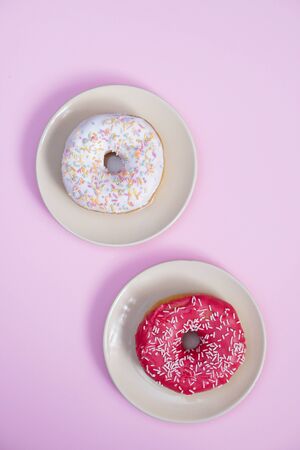 Beautiful juicy donut with a sweet cream.
Cupcake on a pink background for kitchen design.の写真素材