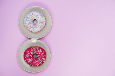Beautiful juicy donut with a sweet cream.
Cupcake on a pink background for kitchen design.の写真素材
