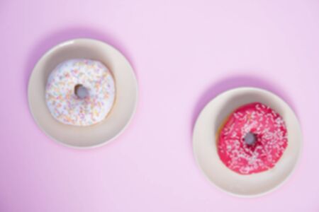 Beautiful juicy donut with a sweet cream.
Cupcake on a pink background for kitchen design.の写真素材