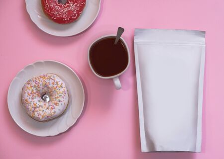 Template of paper ecological bag for storing coffee, tea and donuts with a cup of cappuccino. Vacuum packaging for christmas and new year presentの写真素材