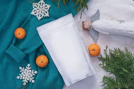 Template of ecological paper bag for storing coffee, tea on the background of decorations and adornments. Vacuum packaging for christmas and new year presentの写真素材