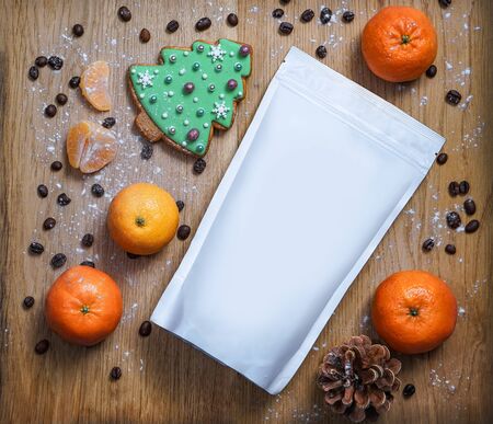 Template of paper ecological bag for storing coffee, tea with cookies in pines and tangerines. Vacuum packaging for christmas and new year presentの写真素材
