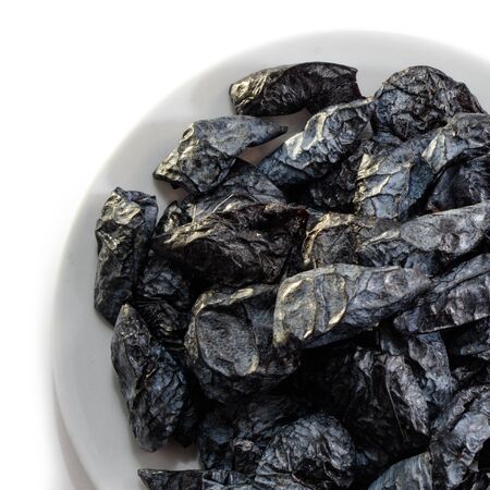 Prunes on a white isolated background. Food for your website design. kitchen theme cuisine and cookingの写真素材