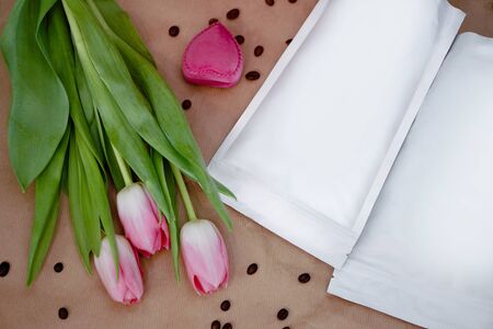 Beautiful spring bouquet with a pack of coffee for your decoration. Template for your brand on the packaging. Layout for the design of your logoの写真素材