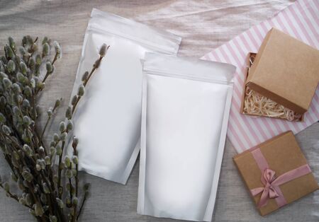 Beautiful spring bouquet with a pack of coffee for your decoration. Template for your brand on the packaging. Layout for the design of your logoの写真素材